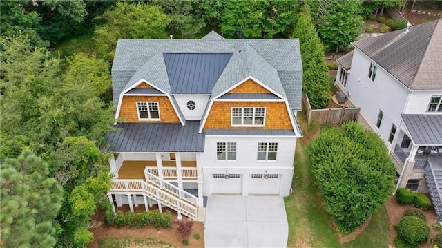 view of front of house featuring metal roof, a gambrel roof, stairs, and a standing seam roof