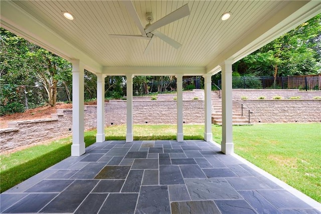 view of patio featuring stairway and fence