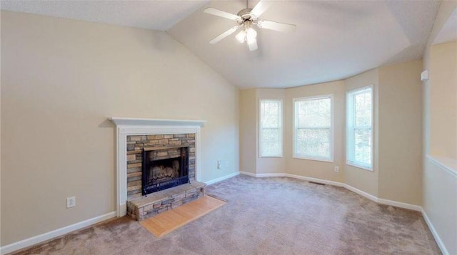 unfurnished living room with ceiling fan, light colored carpet, lofted ceiling, and a fireplace