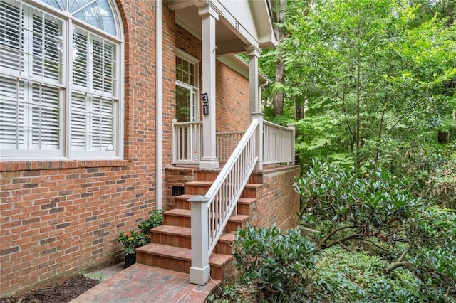 entrance to property featuring brick siding