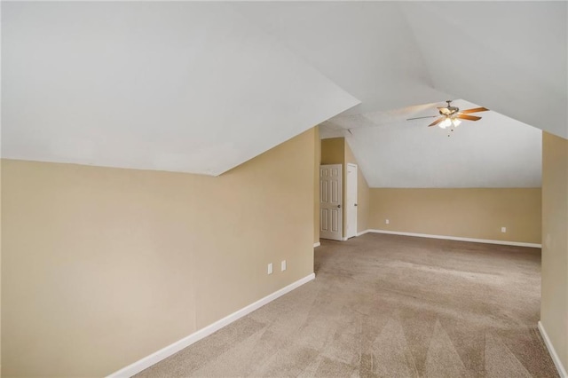 additional living space featuring light carpet, vaulted ceiling, and ceiling fan