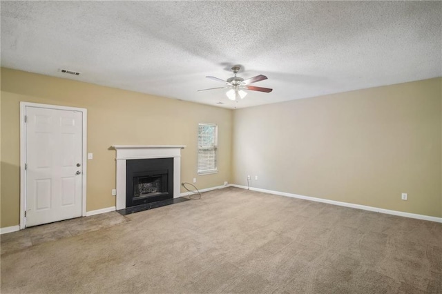 unfurnished living room with carpet, a textured ceiling, and ceiling fan