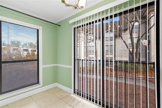 doorway to outside featuring tile patterned floors and ornamental molding