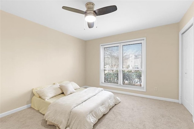 bedroom featuring light carpet and ceiling fan