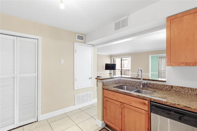 kitchen featuring stone counters, dishwasher, sink, light tile patterned floors, and kitchen peninsula