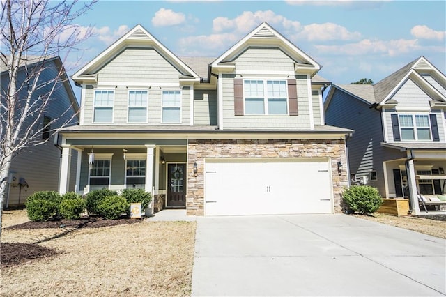 craftsman-style home with driveway, stone siding, an attached garage, and a porch