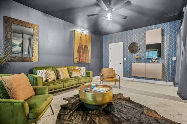 living area featuring carpet and a ceiling fan