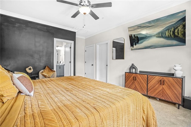 bedroom featuring light colored carpet, crown molding, ensuite bath, and a ceiling fan