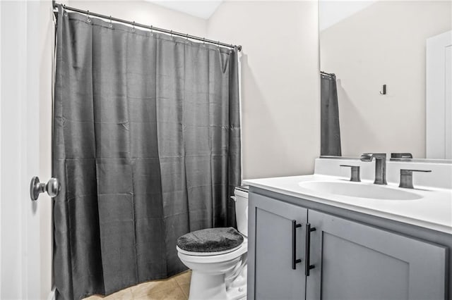 bathroom featuring toilet, vanity, tile patterned flooring, and a shower with shower curtain