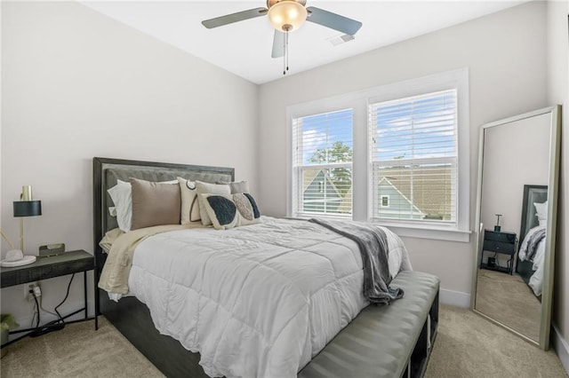 bedroom with light carpet, baseboards, and ceiling fan