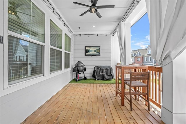 deck featuring a ceiling fan and a grill
