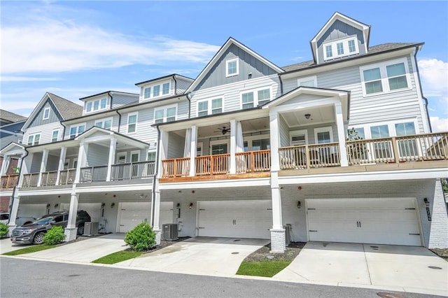 multi unit property with central air condition unit, an attached garage, board and batten siding, and concrete driveway