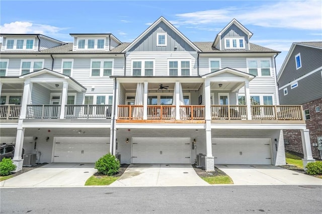 view of front of property featuring an attached garage, central AC unit, board and batten siding, and driveway