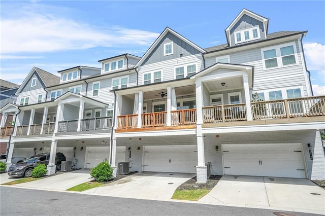 multi unit property featuring a garage, central air condition unit, board and batten siding, and concrete driveway