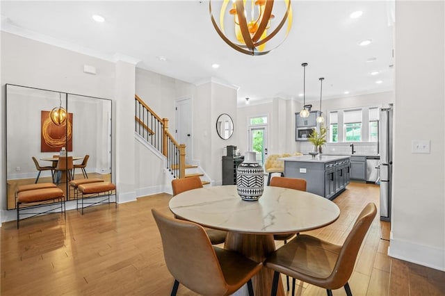 dining room featuring stairway, light wood finished floors, ornamental molding, recessed lighting, and baseboards