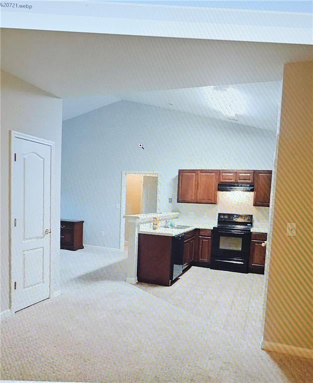 kitchen featuring black appliances, light carpet, and vaulted ceiling