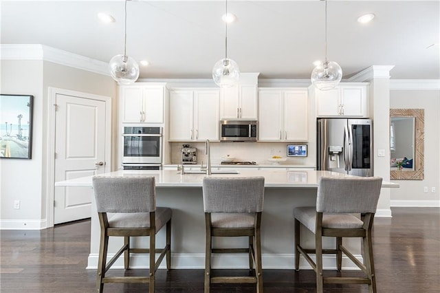 3133 Quinn Pl, Atlanta, GA 30341 - kitchen with appliances with stainless steel finishes, ornamental molding, baseboards, a kitchen island with sink, and backsplash