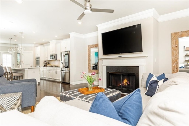 3133 Quinn Pl, Atlanta, GA 30341 - living area featuring a ceiling fan, crown molding, a lit fireplace, dark wood-style flooring, and recessed lighting