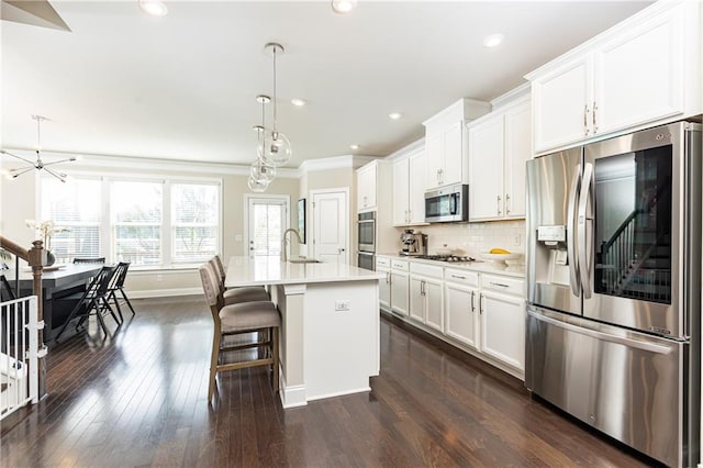 3133 Quinn Pl, Atlanta, GA 30341 - kitchen featuring stainless steel appliances, crown molding, a sink, an island with sink, and light countertops