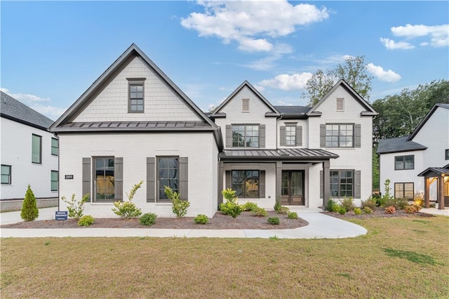 modern inspired farmhouse with covered porch and a front lawn