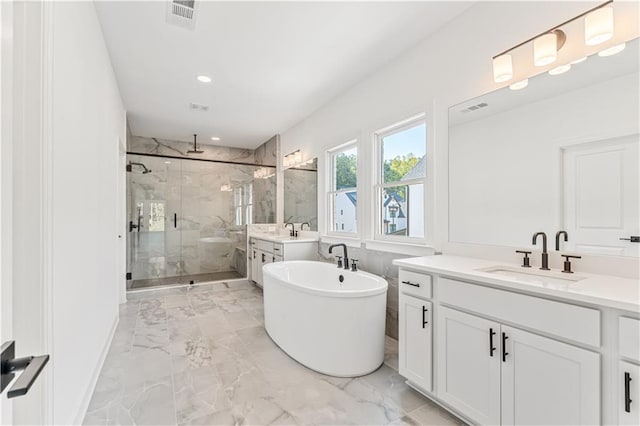 bathroom featuring shower with separate bathtub and vanity