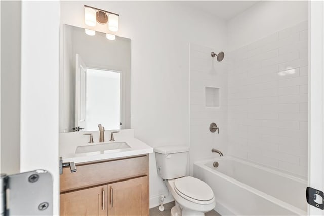 full bathroom featuring tiled shower / bath, vanity, and toilet