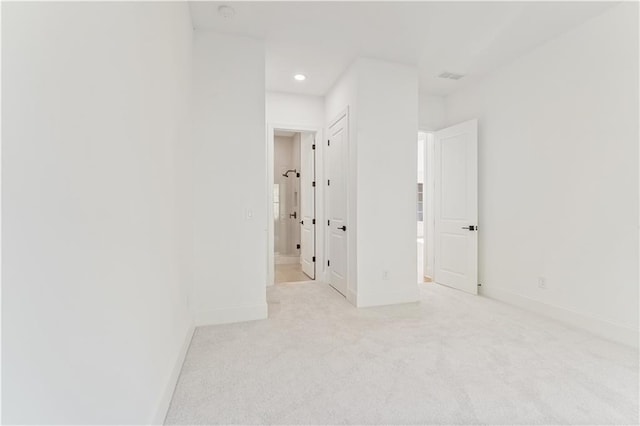 unfurnished room featuring light colored carpet