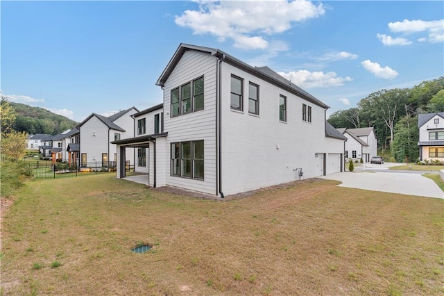 view of side of home with a yard and a garage