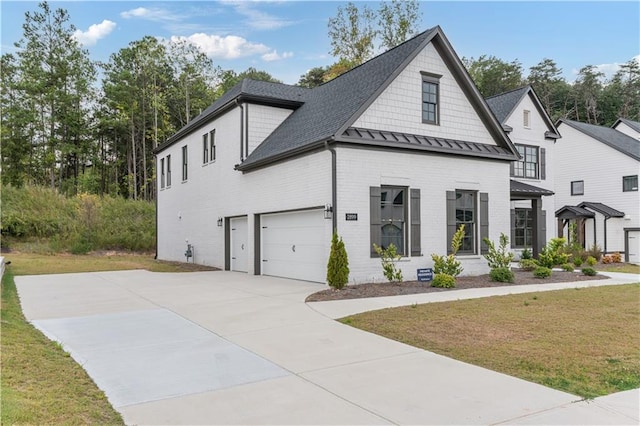 view of front of home with a garage and a front yard