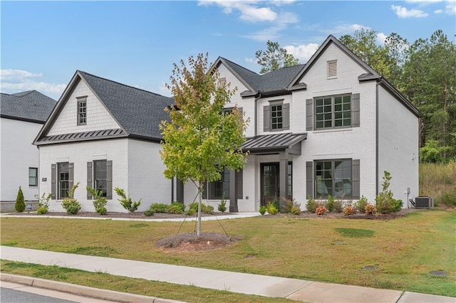 modern farmhouse style home featuring central AC and a front yard