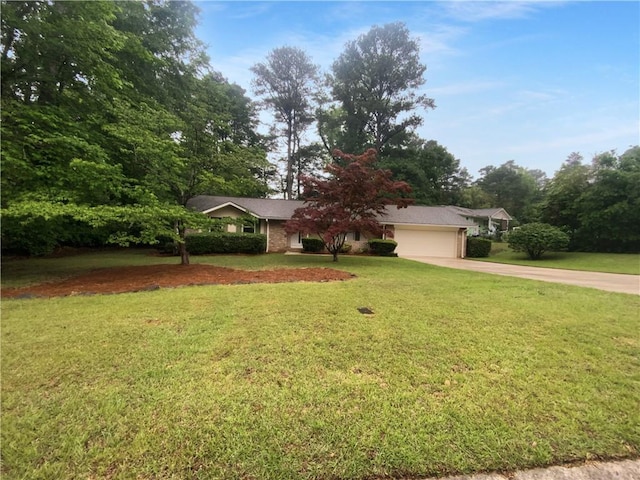 view of front facade with concrete driveway, an attached garage, and a front yard
