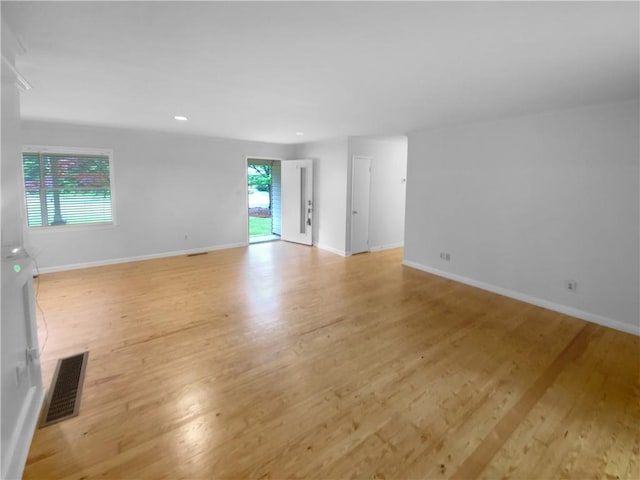 spare room with light wood-style flooring, baseboards, and recessed lighting