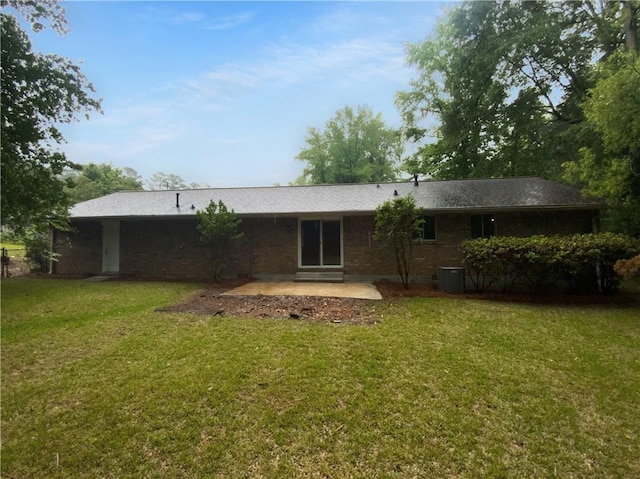 rear view of house featuring a patio and a lawn