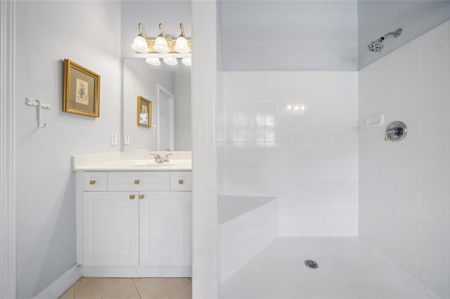 full bathroom featuring vanity, tile patterned flooring, and tiled shower