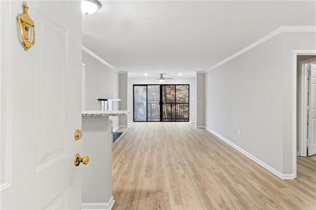 unfurnished living room featuring light hardwood / wood-style flooring, ornamental molding, and ceiling fan