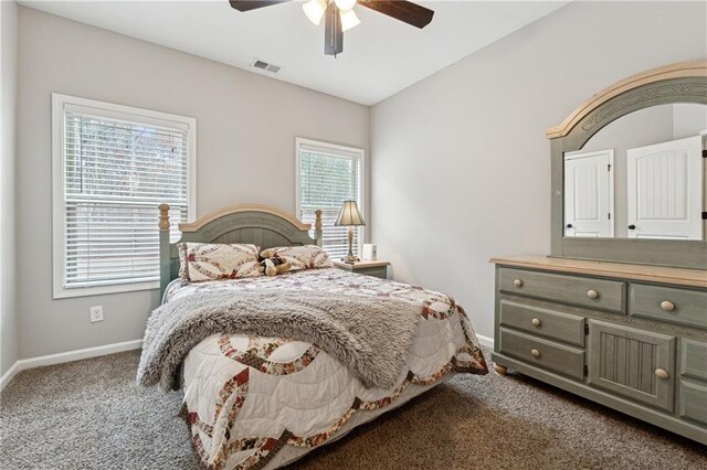 bedroom with carpet floors, multiple windows, and ceiling fan