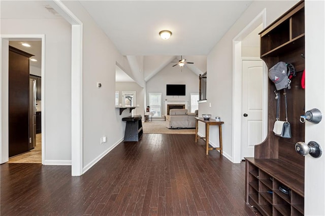 interior space with hardwood / wood-style floors, vaulted ceiling, and ceiling fan