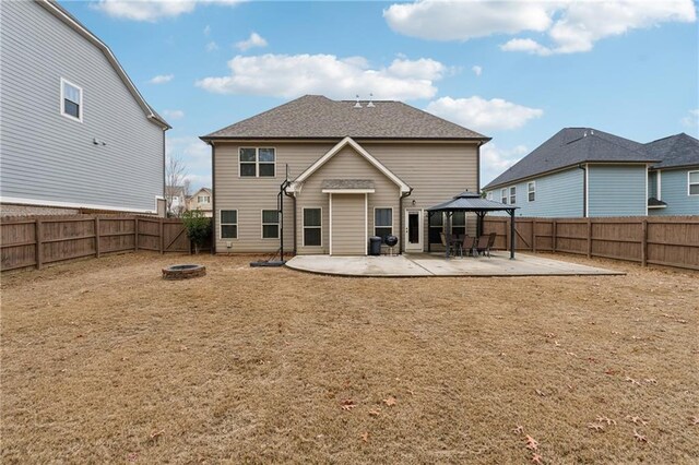 back of property featuring a gazebo, a fire pit, and a patio area