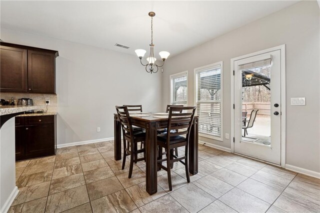 dining space with a chandelier