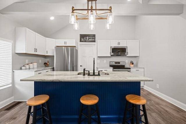 kitchen with dark wood-type flooring, a sink, baseboards, and stainless steel appliances