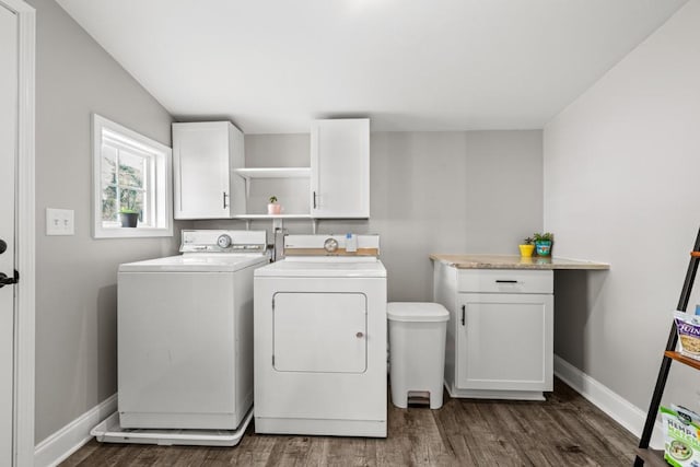 washroom featuring baseboards, dark wood finished floors, cabinet space, and washing machine and dryer