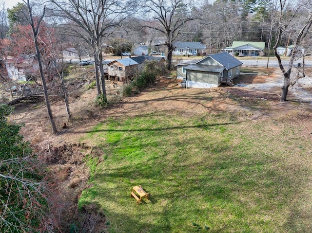 view of yard with a garage and a residential view
