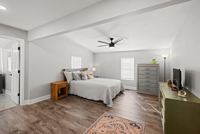 bedroom featuring baseboards, dark wood-style floors, and multiple windows