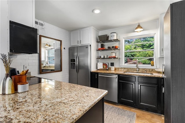 2240 Cheshire Bridge Rd NE Unit 206, Atlanta, GA 30324 - kitchen featuring stainless steel appliances, backsplash, light stone countertops, dark cabinets, and white cabinets
