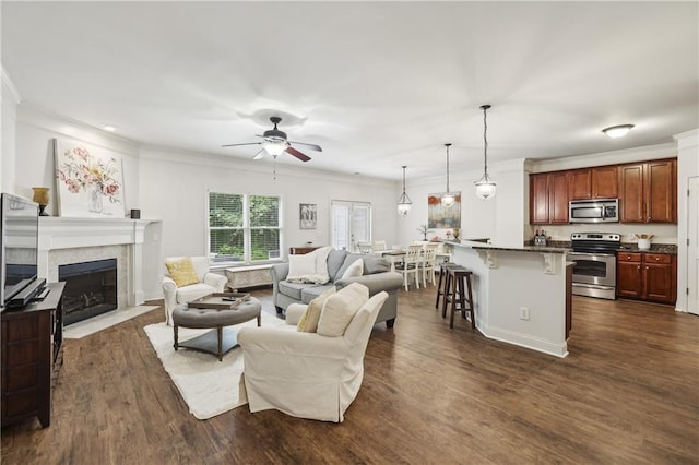 13468 Gardiner Ln, Alpharetta, GA 30004 - living area featuring ceiling fan, ornamental molding, a tile fireplace, and dark wood-style floors