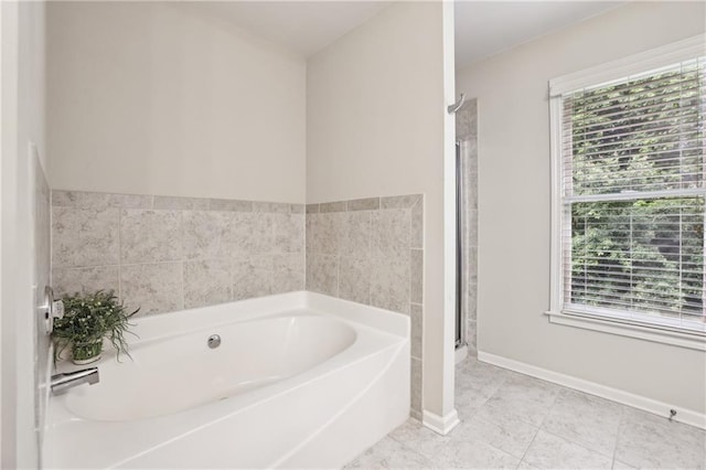 13468 Gardiner Ln, Alpharetta, GA 30004 - bathroom featuring a garden tub, a stall shower, and baseboards