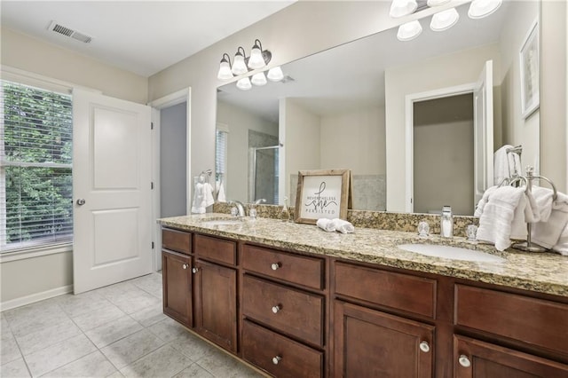13468 Gardiner Ln, Alpharetta, GA 30004 - bathroom featuring double vanity, tile patterned floors, a stall shower, and baseboards