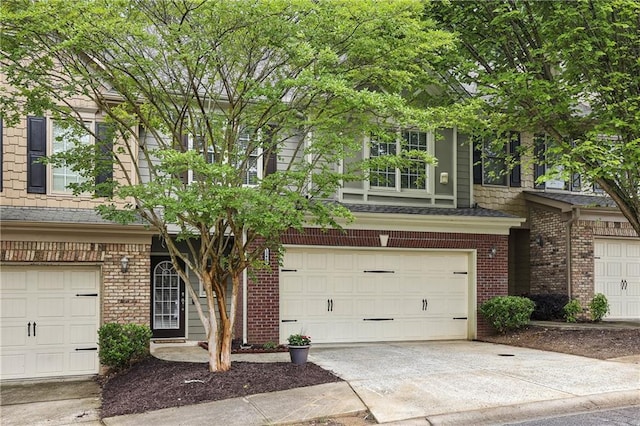 13468 Gardiner Ln, Alpharetta, GA 30004 - view of front facade with brick siding, a garage, and driveway