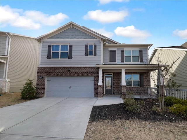 craftsman inspired home featuring a garage, covered porch, brick siding, and driveway