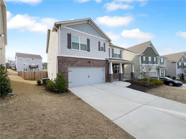 view of front facade with a garage, a residential view, fence, and brick siding